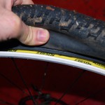 Press tire bead away from rim on both sides