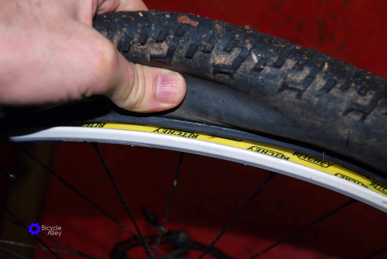 Press tire bead away from rim on both sides