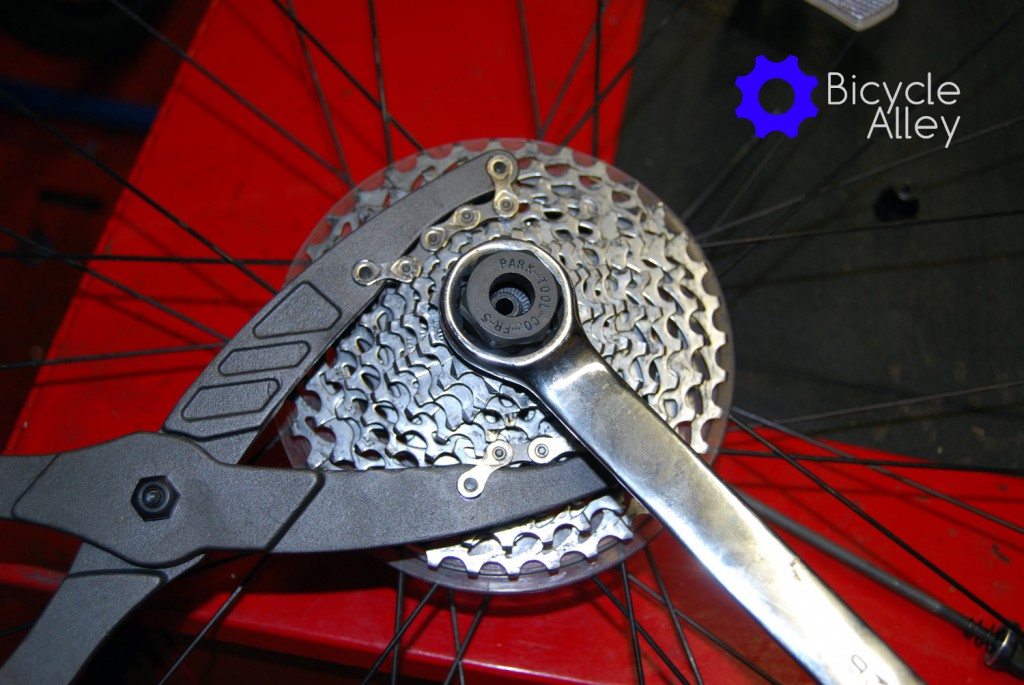 The 10 speed cassette being held by the Park Tools CP-1 pliers, and a 26mm wrench turning the Park Tools FR-5 lockring tool.